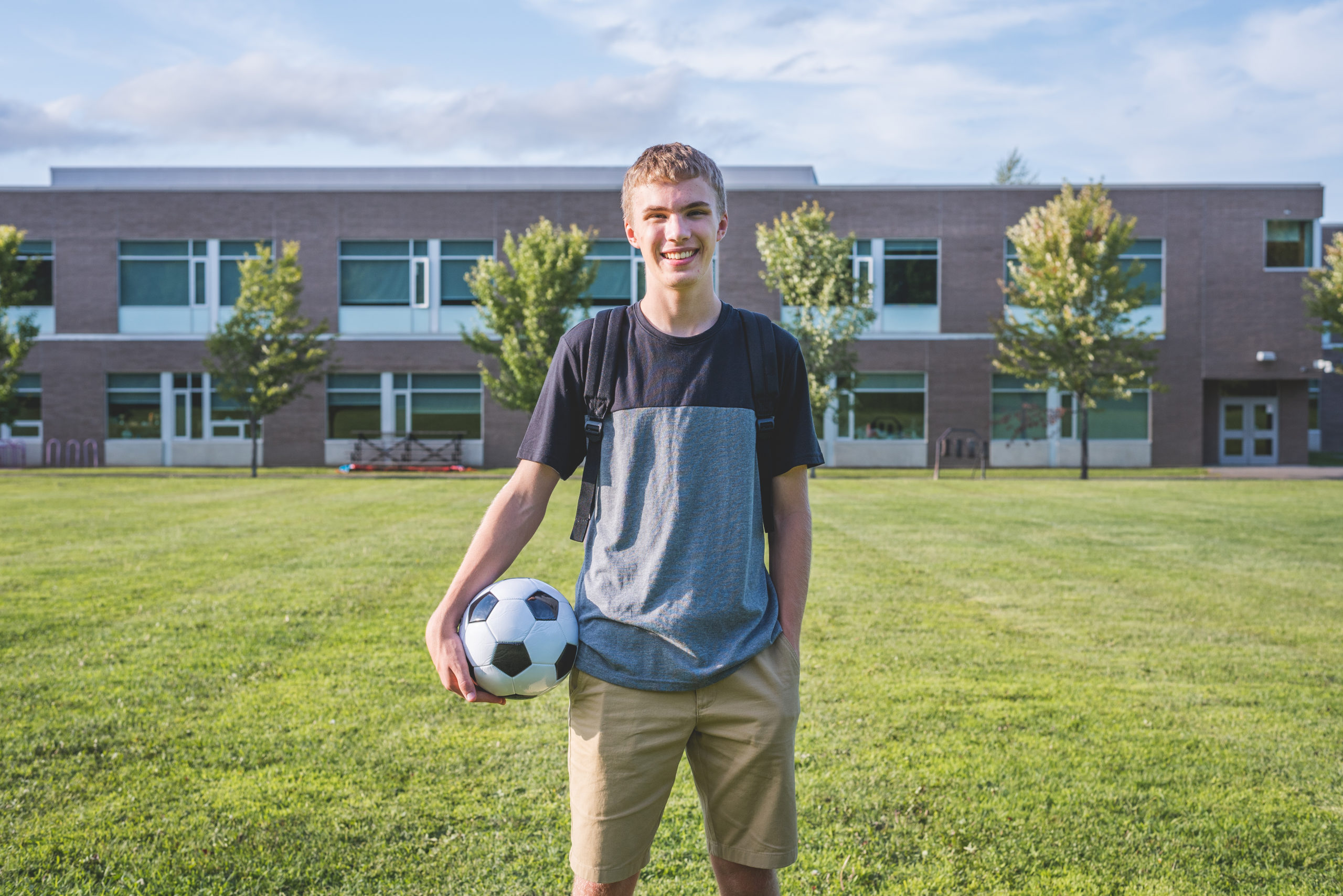 Young College Athlete Holding A Soccer Ball On College Campus