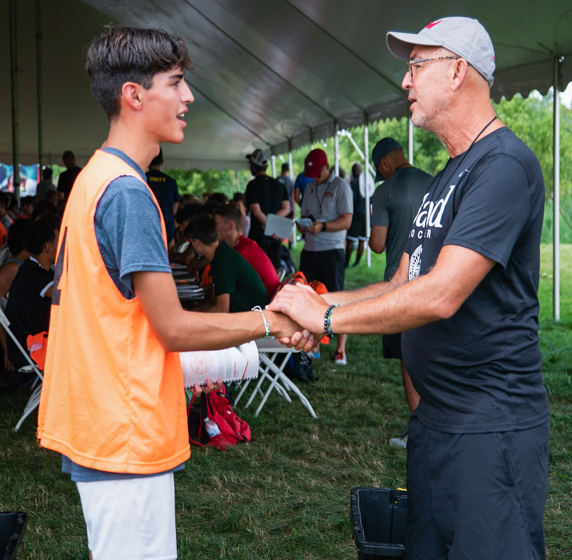 EXACT Sports athlete meeting 1:1 with a college coach at camp